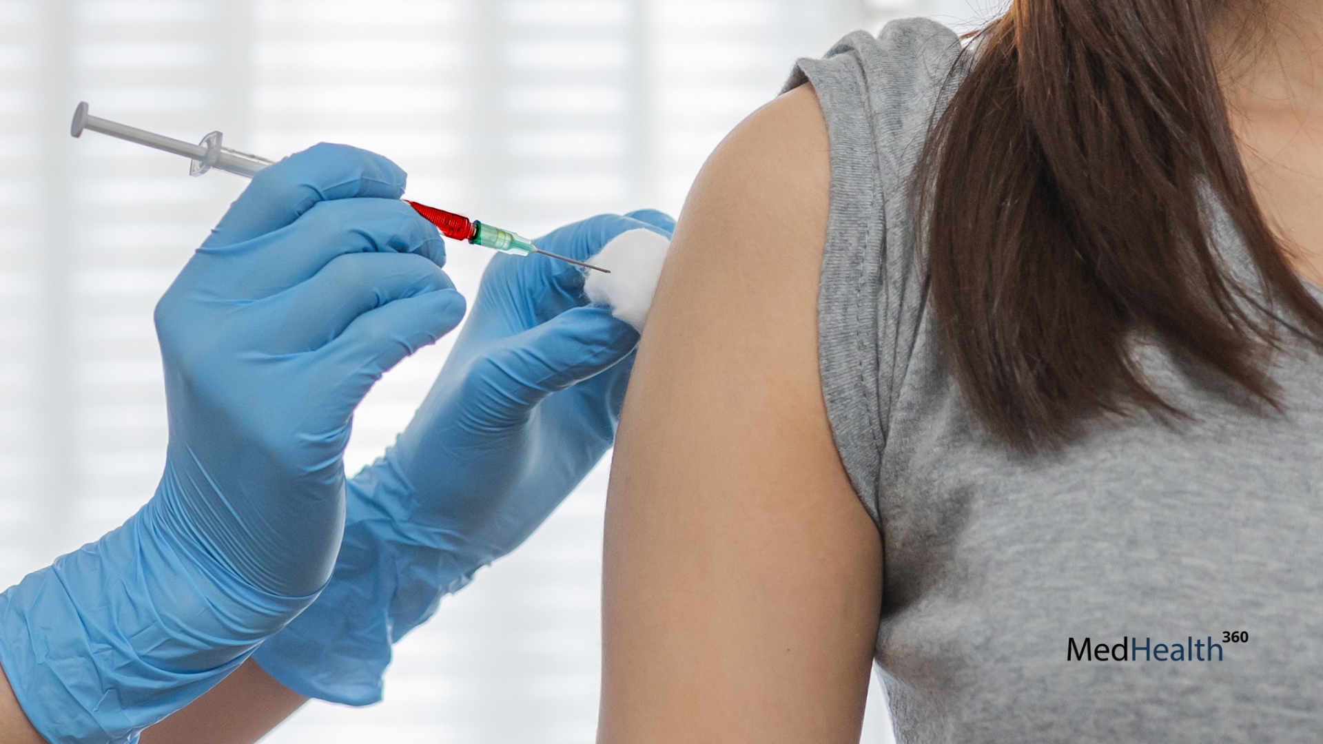 A healthcare professional administering a Vitamin B12 injection into a patient's arm with a syringe.
