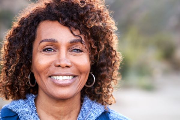 Portrait Of Smiling African American Senior Woman Outdoors In Countryside